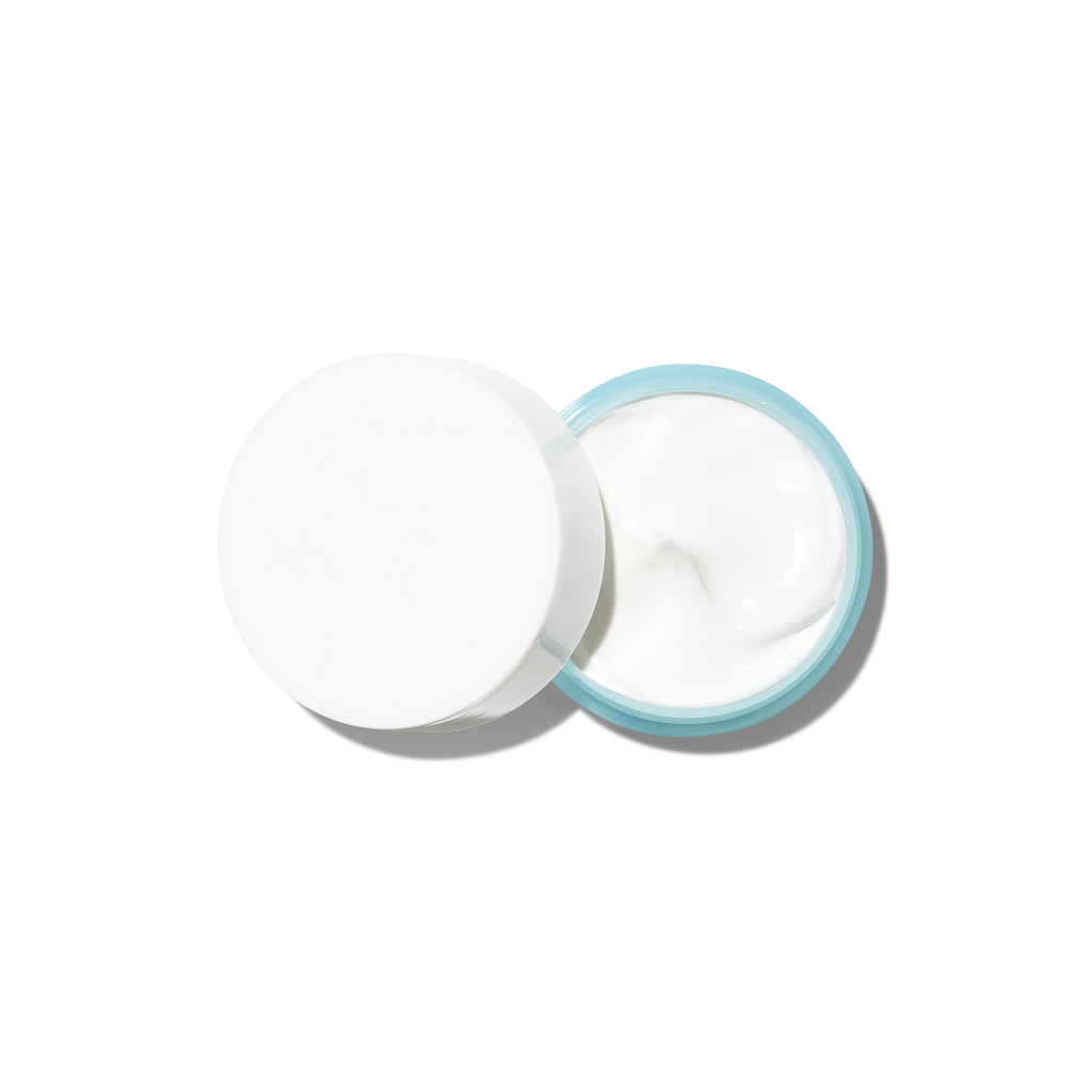 Open jar of face cream with a white lid